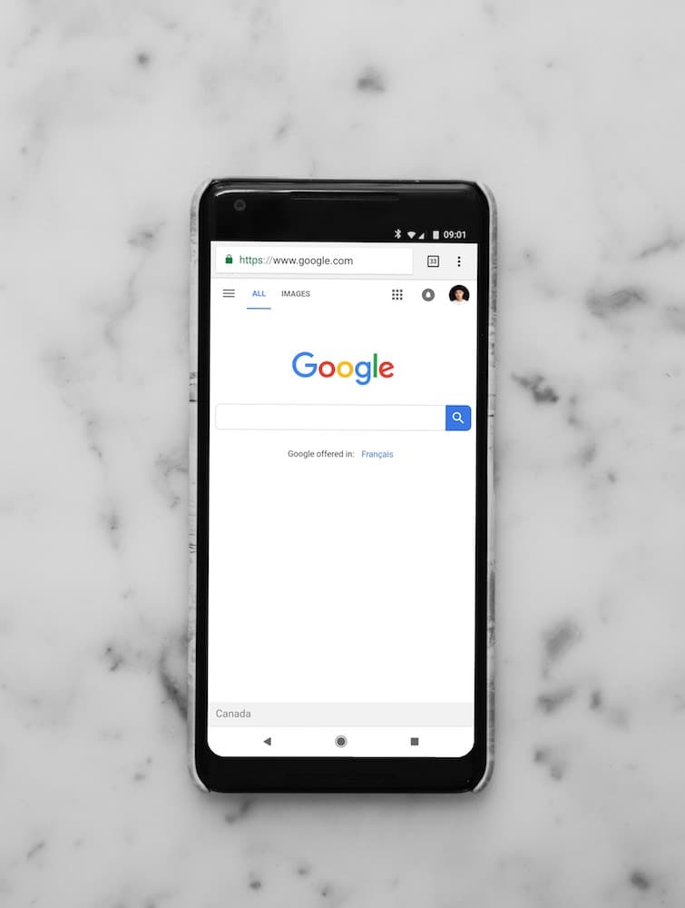 Image depicting a phone with a google search browser tab open